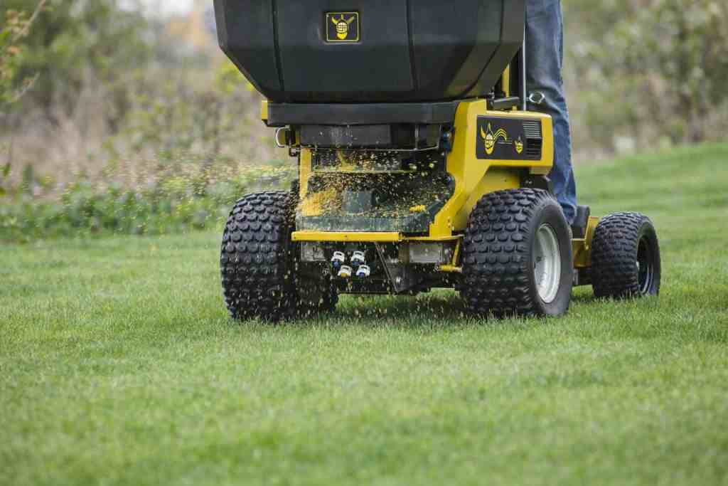Fertilizer spreader in action on lawn