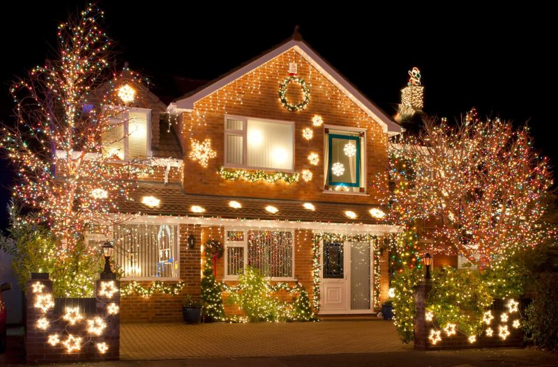 Warm white holiday lighting on a Fuquay-Varina, NC home's rooflines and shrubs Professional holiday lighting installed on a home in Willow Spring, NC