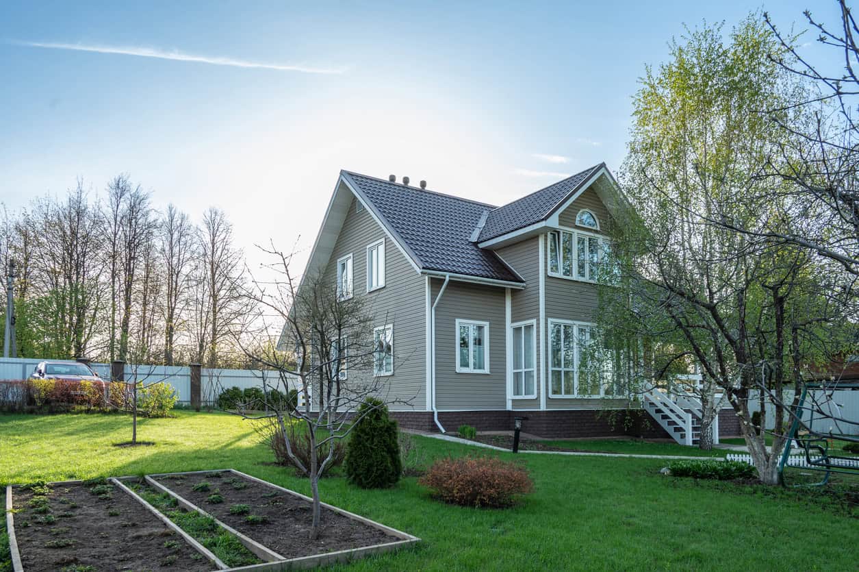 Residential home with green lawn and garden beds in Fuquay-Varina NC