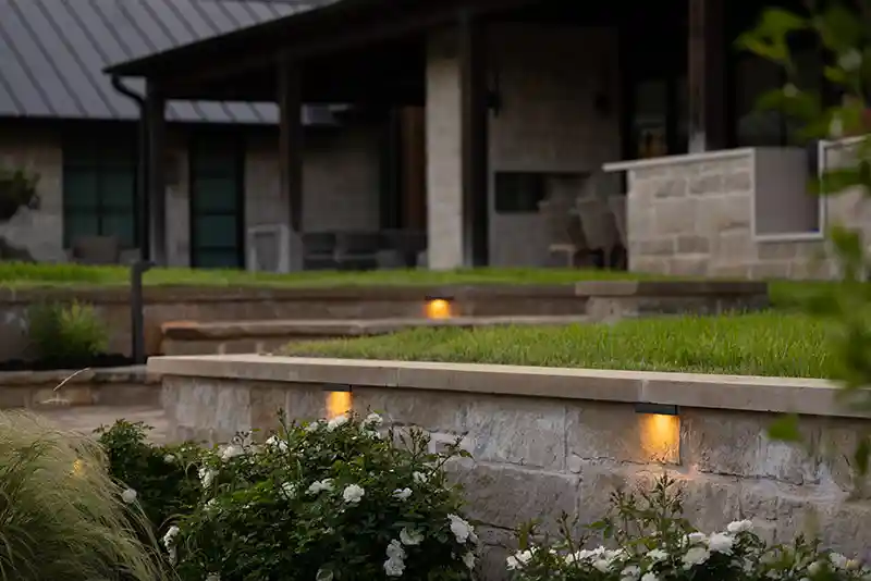 Hardscape lights set into stone steps and a retaining wall at a Fuquay-Varina, NC home Step, deck, and hardscape lighting on a patio in Willow Spring, NC