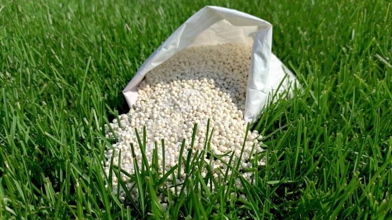 Bag of fertilizer on a North Carolina lawn by Lawn Panther
